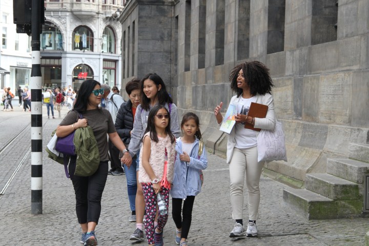 Debora doing a tour in Amsterdam with some kids by her side and one adult