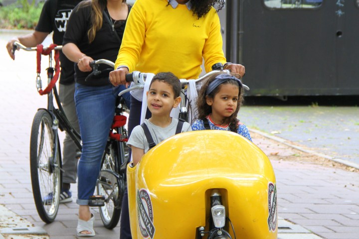 Debora on a clog bike with two kids