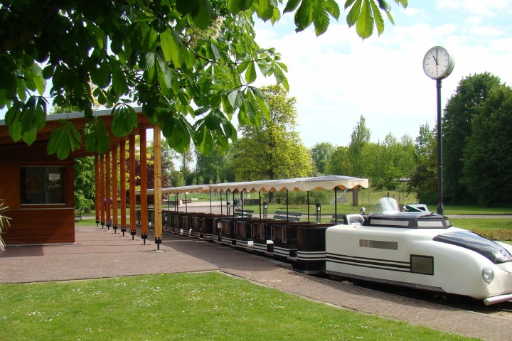 An open sightseeing passenger train in nature