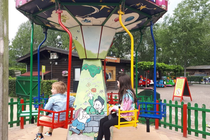 Two kids on a carrussel