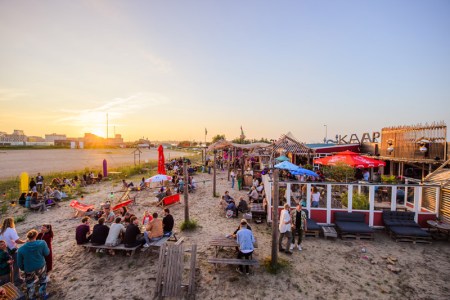 a group of people sitting at a beach